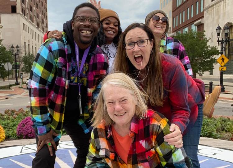 3 people wearing tye-dye posing