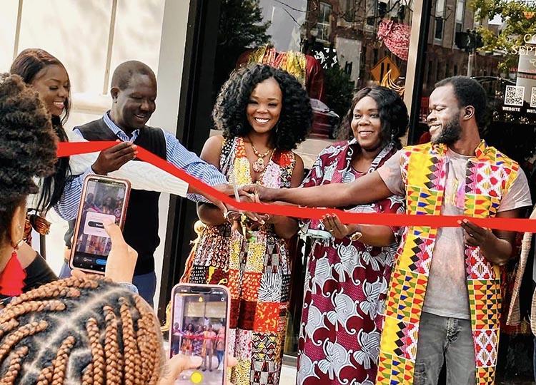 Ribbon cutting ceremony in front of new storefront